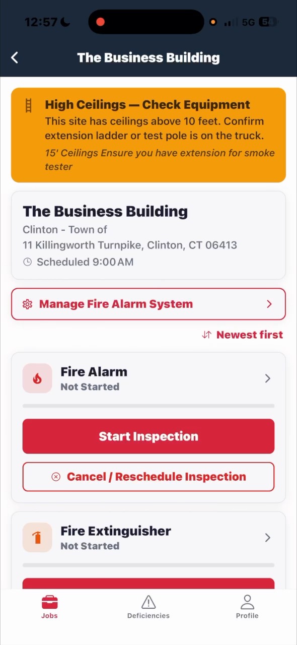 The CodeGreen ITM app on a phone, showing a job with fire alarm and fire extinguisher inspections ready to start